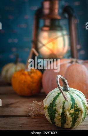 Mini pumpkins and lantern on wooden background Stock Photo