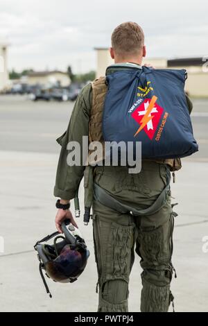 U.S. Marine Corps Capt. Jared G. Cox, a pilot assigned to Marine Fighter Attack Squadron 251, leaves the flightline after a flight, during Red Flag-Alaska 17-2 on Joint Base Elmendorf-Richardson, Alaska, June 19, 2017. Red Flag-Alaska provides an optimal training environment in the Indo-Asian Pacific region and focuses on improving ground, space, and cyberspace combat readiness and interoperability for U.S. and international forces. Stock Photo