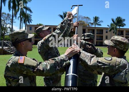 Indirect fire infantryman assigned to Troop A, 3rd Squadron, 4th Cavalry Regiment, 3rd Brigade Combat Team, 25th Infantry Division, work together as a team using a cartridge extractor to simulate the removal of a 120 mm mortar from a M120 Mortar System at Schofield Barracks, Hawaii, on June 22, 2017. The Soldiers were participating in this troop’s weekly sergeant’s time training on the M120. Stock Photo