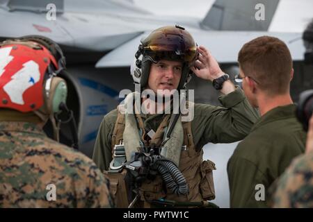 U.S. Marine Corps Capt. Jared G. Cox, a pilot assigned to Marine Fighter Attacks Squadron 251, gives a pilot debrief after a flight during Red Flag-Alaska 17-2 on Joint Base Elmendorf-Richardson, Alaska, June 21, 2017. Red Flag-Alaska provides an optimal training environment in the Indo-Asian Pacific region and focuses on improving ground, space, and cyberspace combat readiness and interoperability for U.S. and international forces. Stock Photo