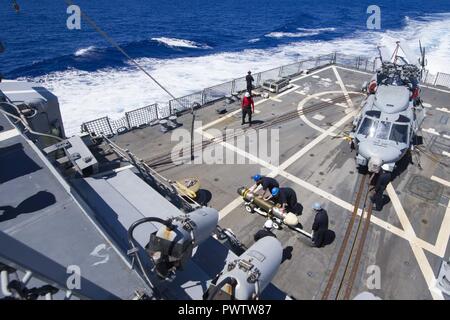 Sailors transport a Mark 46 Mod 5A torpedo across the flight deck of ...