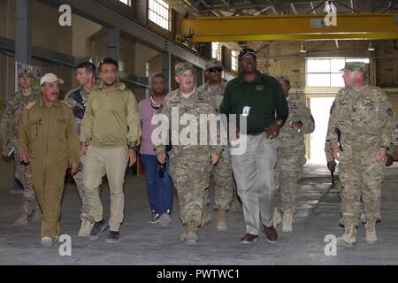 U.S. Army Maj. Gen. Flem Walker, commanding general of 1st Sustainment Command (Theater) and the deputy commanding general-sustainment for United States Army Central, visits the Logistical Operations Center-Taji warehouse facility at Camp Taji, Iraq, June 17, 2017. Walker received an overview of the U.S. Army logistic capability after taking command on May 15, 2017. His visit will assist in increasing partner forces capability as an integral part of the Combined Joint Task Force – Operation Inherent Resolve building partner capacity mission by training and improving the capability of partnered Stock Photo