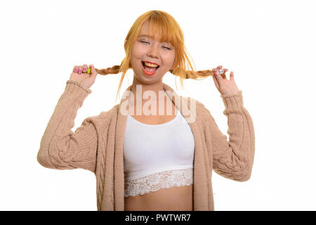 Young happy Asian woman smiling and playing with her hair Stock Photo