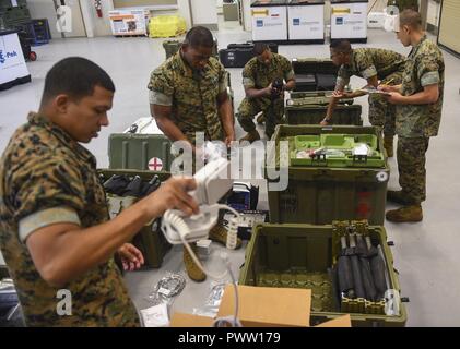 U.S. Marine Corps and U.S. Navy personnel from the Combat Logistics Battalion 451 Detachment 3, work together to conduct inventory checks on equipment at Joint Base Charleston - Weapons Station, S.C., June 21, 2017. In addition to preparing medical logistics, the unit trains to perform military honors at funerals for any members who have honorably served in the U.S. Marine Corps within a 200-mile radius of the base. Stock Photo