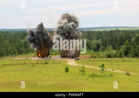 U.S. Soldiers assigned to 20th CBRNE Command, and Louisiana State Police Emergency Services dispose of ordnance during Raven’s Challenge 2017 at Camp Shelby, Miss., June 28, 2017. Raven’s Challenge is an annual event that provides Explosive Ordnance Disposal personnel and Public Safety Bomb Squads of both military and government agencies interoperability in a realistic domestic tactical environment. Stock Photo