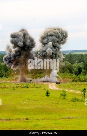 U.S. Soldiers assigned to 20th CBRNE Command, and Louisiana State Police Emergency Services dispose of ordnance during Raven’s Challenge 2017 at Camp Shelby, Miss., June 28, 2017. Raven’s Challenge is an annual event that provides Explosive Ordnance Disposal personnel and Public Safety Bomb Squads of both military and government agencies interoperability in a realistic domestic tactical environment. Stock Photo