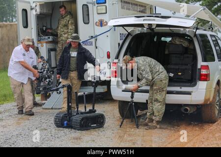 U.S. Soldiers assigned to 705th EOD Company, 63rd EOD Battalion, 52nd EOD Group, 20th CBRNE Command, and personnel assigned to Rapides Parish Sheriff’s Office, La., use robots to inspect a cabin with explosives during Raven’s Challenge 2017 at Camp Shelby, Miss., June 29, 2017. Raven’s Challenge is an annual event that provides Explosive Ordnance Disposal personnel and Public Safety Bomb Squads of both military and government agencies interoperability in a realistic domestic tactical environment. Stock Photo