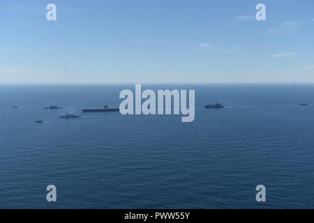 ATLANTIC OCEAN (June 27, 2017) The aircraft carrier USS Dwight D. Eisenhower (CVN 69)(Ike), the Arleigh Burke-class guided-missile destroyer USS Winston S. Churchill (DDG 81), the guided-missile cruiser USS San Jacinto (CG 56), the Military Sealift Command dry cargo and ammunition ship USNS Robert E. Perry (T-AKE 5), the Royal Canadian Navy frigate HMCS Charlottetown (FFH 339), the Royal Canadian Navy Kingston-class maritime coastal defense vessel HMCS Glace Bay (MM 701), and the Royal Canadian Navy Kingston-class maritime coastal defense vessel HMCS Moncton (MM 708) transit the Atlantic Ocean Stock Photo