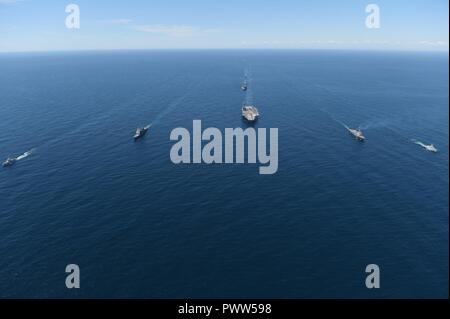 ATLANTIC OCEAN (June 27, 2017) The aircraft carrier USS Dwight D. Eisenhower (CVN 69)(Ike), the Arleigh Burke-class guided-missile destroyer USS Winston S. Churchill (DDG 81), the guided-missile cruiser USS San Jacinto (CG 56), the Military Sealift Command dry cargo and ammunition ship USNS Robert E. Perry (T-AKE 5), the Royal Canadian Navy frigate HMCS Charlottetown (FFH 339), the Royal Canadian Navy Kingston-class maritime coastal defense vessel HMCS Glace Bay (MM 701), and the Royal Canadian Navy Kingston-class maritime coastal defense vessel HMCS Moncton (MM 708) transit the Atlantic Ocean Stock Photo