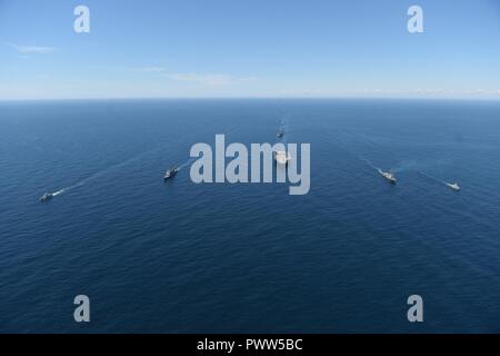 ATLANTIC OCEAN (June 27, 2017) The aircraft carrier USS Dwight D. Eisenhower (CVN 69)(Ike), the Arleigh Burke-class guided-missile destroyer USS Winston S. Churchill (DDG 81), the guided-missile cruiser USS San Jacinto (CG 56), the Military Sealift Command dry cargo and ammunition ship USNS Robert E. Perry (T-AKE 5), the Royal Canadian Navy frigate HMCS Charlottetown (FFH 339), the Royal Canadian Navy Kingston-class maritime coastal defense vessel HMCS Glace Bay (MM 701), and the Royal Canadian Navy Kingston-class maritime coastal defense vessel HMCS Moncton (MM 708) transit the Atlantic Ocean Stock Photo