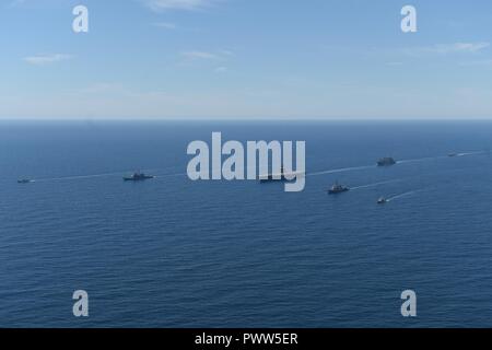 ATLANTIC OCEAN (June 27, 2017) The aircraft carrier USS Dwight D. Eisenhower (CVN 69)(Ike), the Arleigh Burke-class guided-missile destroyer USS Winston S. Churchill (DDG 81), the guided-missile cruiser USS San Jacinto (CG 56), the Military Sealift Command dry cargo and ammunition ship USNS Robert E. Perry (T-AKE 5), the Royal Canadian Navy frigate HMCS Charlottetown (FFH 339), the Royal Canadian Navy Kingston-class maritime coastal defense vessel HMCS Glace Bay (MM 701), and the Royal Canadian Navy Kingston-class maritime coastal defense vessel HMCS Moncton (MM 708) transit the Atlantic Ocean Stock Photo