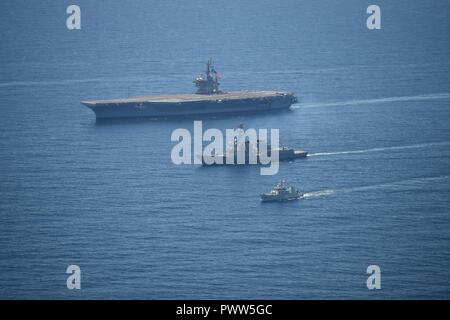 ATLANTIC OCEAN (June 27, 2017) The aircraft carrier USS Dwight D. Eisenhower (CVN 69), left, the Arleigh Burke-class guided-missile destroyer USS Winston S. Churchill (DDG 81) and the Royal Canadian Navy Kingston-class maritime coastal defense vessel HMCS Moncton (MM 708) transit the Atlantic Ocean. Dwight D. Eisenhower is underway conducting a bilateral group sail with the Canada 150 anniversary celebration. ( Stock Photo