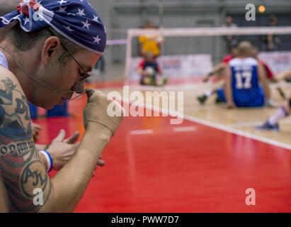 U.S. Air Force Staff Sgt. David Olsen, an explosive ordinance disposal troop from Abilene, Texas., says a silent prayer during a sitting volleyball match at the 2017 Warrior Games June 30, 2017 at McCormick Place-Lakeside Center, Chicago, Ill. Approximately 250 seriously wounded, ill and injured service members and veterans will participate in this year’s competition, representing the Army, Marine Corps, Navy, Coast Guard, Air Force and U.S. Special Operations Command. Olsen is also a member of the Air Force track and field teams competing in the games. Stock Photo