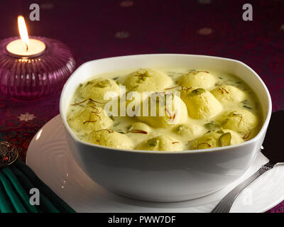 RASMALAI, AN INDIAN DESSERT MADE FROM COTTAGE CHEESE SOAKED IN SWEET SAFFRON MILK AND GARNISHED WITH PISTACHIO Stock Photo