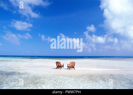 Two beach chairs on tropical sandbar in the caribbean. Stock Photo