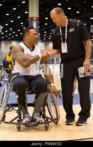 U.S. Army veteran Faataui David Iuli shakes hands with Col. Mathew St. Laurent after competing in wheelchair basketball for the 2017 Department of Defense Warrior Games at Chicago, Ill., June 29, 2017. The DOD Warrior Games are an adaptive sports competition for wounded, ill and injured service members and veterans. Approximately 265 athletes representing teams from the Army, Marine Corps, Navy, Air Force, Special Operations Command, United Kingdom Armed Forces, and the Australian Defence Force will compete June 30 - July 8 in archery, cycling, track, field, shooting, sitting volleyball, swimm Stock Photo