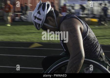 U.S. Army veteran Jarred Vaina participates in the wheelchair racing competition during the track event for the 2017 Department of Defense Warrior Games at Chicago, Ill., July 2, 2017. The DOD Warrior Games are an annual event allowing wounded, ill and injured service members and veterans in Paralympic-style sports including archery, cycling, field, shooting, sitting volleyball, swimming, track and wheelchair basketball. Stock Photo