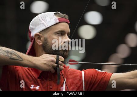 Marine Corps veteran SSgt. Matthew Francis competes in archery during the 2017 Department of Defense ) Warrior Games at McCormick Place in Chicago, Ill., July 3, 2017. The DoD Warrior Games are an annual event allowing wounded, ill and injured service members and veterans to compete in Paralympic-style sports including archery, cycling, field, shooting, sitting volleyball, swimming, track and wheelchair basketball. Stock Photo