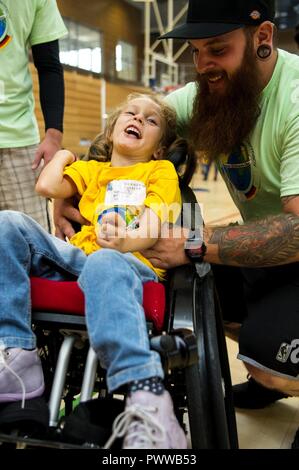 Theresa Hermes, left, Bitburg student, laughs with Mirius Zender, right, event volunteer, during the St. Martins Special Children's Day at Spangdahlem Air Base, Germany, June 28, 2017. The event marked the 25th year where students with special needs around the area were invited to participate in activities with volunteers. Stock Photo