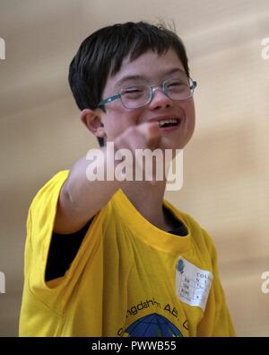 Nils Collins, student from St. Martins School in Bitburg, laughs during the St. Martin Special Children's Day at Spangdahlem Air Base, Germany, June 28, 2017. Each student from the event was paired up with a volunteer to participate in a variety of activities including basketball throw, hula-hooping, balance beam and bowling. Stock Photo