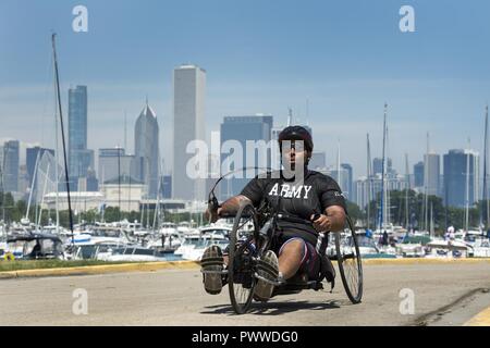 Army Sgt. Christopher McGinnis powers a hand cycle during the 2017 Dept. of Defense Warrior Games in Chicago July 6, 2017. The DoD Warrior Games are an annual event allowing wounded, ill and injured service members and veterans to compete in Paralympic-style sports. Stock Photo