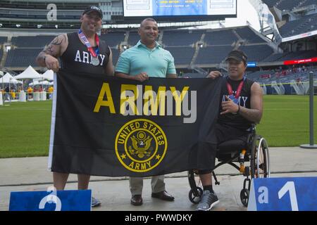 U.S. Army Staff Sgt. Gregory Quarles, from Ringgold, Ga., and veteran Jarred Vaina receive medals during the field  competition for the 2017 Department of Defense Warrior Games at Chicago, Ill., July, 5, 2017. The DOD Warrior Games are an annual event allowing wounded, ill and injured service members and veterans in Paralympic-style sports including archery, cycling, field, shooting, sitting volleyball, swimming, track and wheelchair basketball. Stock Photo