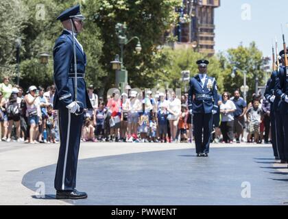 Capt. Riley Platt, U.S. Air Force Honor Guard Drill Team commander, directs his Airmen at Disney’s California Adventure Park in Anaheim, Ca., June 28, 2017. In order to perform across the country and with collective accuracy, the team practiced the routine approximately six times together before leaving Joint Base Anacostia-Bolling, District of Colombia, and prior to the start of each performance day on the trip. Stock Photo
