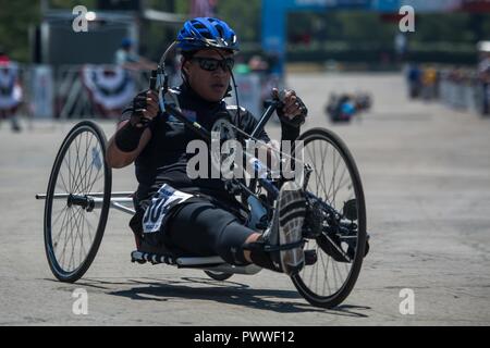 U.S. Army veteran Jarred Vaina rounds conner entering his second lap in the cycling event for the 2017 Department of Defense Warrior Games at Chicago, Ill., July 6, 2017. The DOD Warrior Games are an annual event allowing wounded, ill and injured service members and veterans in Paralympic-style sports including archery, cycling, field, shooting, sitting volleyball, swimming, track and wheelchair basketball. Stock Photo