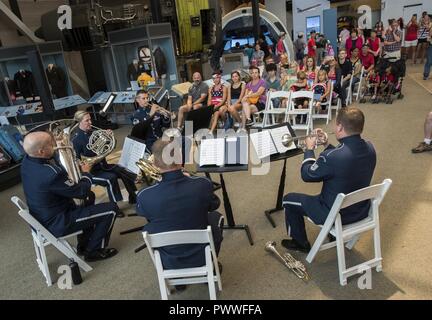 A brass quintet from the United States Air Force Band's Ceremonial Brass perform a series of concerts at the Smithsonian's Air and Space Museum July 4, 2017, Washington, D.C. Members of the quintet include: on Trumpet are Master Sgt. Karl Sweedy and Tech. Sgt. Michael Brest, on French Horn is Master Sgt. Kathleen Fitzpartin, on Trombone is Master Sgt. Aaron Moats and on Tuba is Tech. Sgt. Jess Lightner. Stock Photo