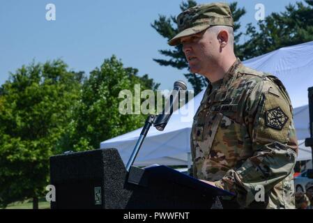 FORT MEADE, Md. --  Lt. Col. Eric S. Fowler addresses the formation as he assumes command of the 741st Military Intelligence battalion from Lt. Col. Galen R. Kane, during a change of command ceremony on June 30. Stock Photo