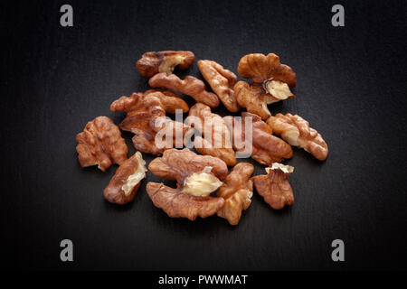 Walnuts on a black slate background. Close up. Stock Photo