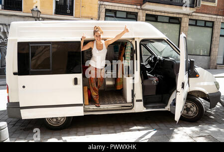 Happy beautiful yong woman traveling by camper van around Europe in Life Inspiration Camper van life Van adventure Road trip and traveling on budget c Stock Photo