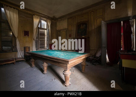 Interior view of room with a pool table in an abandoned castle in France. Stock Photo