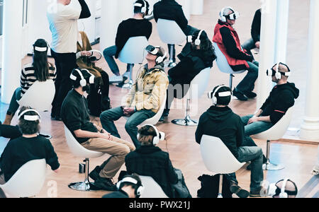 Group of people sitting by themselves using Virtual Reality glasses Stock Photo