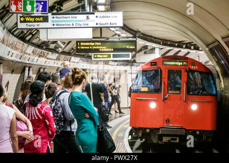 London England,UK,underground subway tube,platform,train,arriving,Bakerloo Line,man men male,woman female women,commuters,waiting,riders,UK GB English Stock Photo