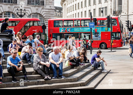 London England,UK,West End Piccadilly Circus,St. James's,Shaftesbury Memorial Fountain,steps,man men male,woman female women,boy boys,kid kids child c Stock Photo