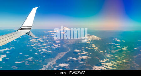 Mount Rainier's white peaks seen from an airplane Stock Photo