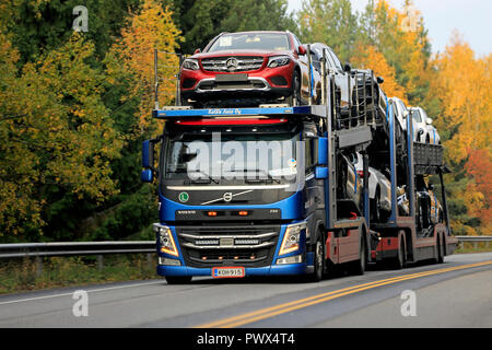 Salo, Finland - October 13, 2018: Blue Volvo FM car carrier of KaWa Auto Oy hauls new Mercedes-Benz vehicles on highway on day of autumn in Finland. Stock Photo
