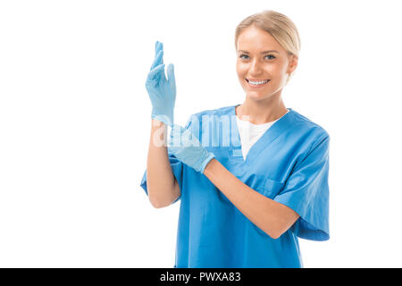 happy young nurse putting on rubber gloves isolated on white Stock Photo