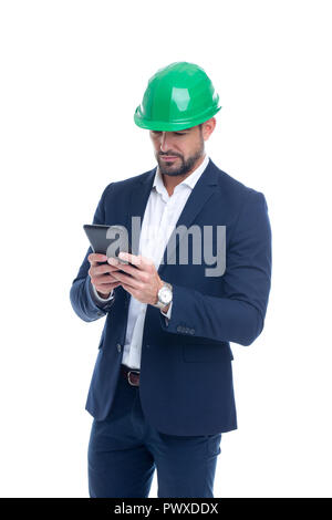 Young caucasian engineer in formal wear using digital tablet isolated on white Stock Photo