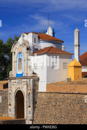 Portugal, Alentejo region, Elvas. An ornate city gate and chapel in the ancient fortified city wall. The border town is a UNESCO World Heritage Site. Stock Photo