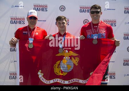 U.S. Marine Corps Gunnery Sgt. John Ayo, left, Cpl. Dakota Boyer, center, and Lance Cpl. Andrew Harris, right, pose for a photo after receiving their medals for the 2017 DoD Warrior Games Cycling Competition. The DoD Warrior Games is an adaptive sports competition for wounded, ill and injured service members and veterans. Stock Photo