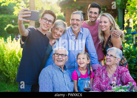 during a bbq a teenager does a selfie with the whole family Stock Photo