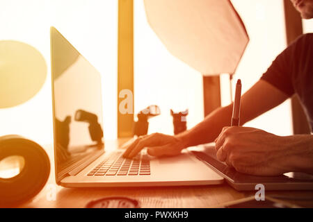 Portrait of a photographer working on pc in his studio Stock Photo