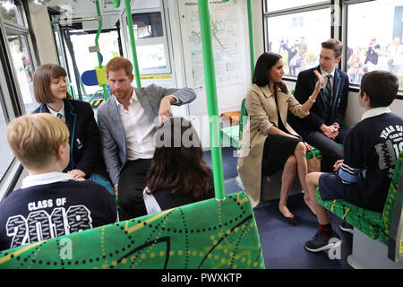 The Duke and Duchess of Sussex talks to students from Albert Park Primary School, Port Melbourne Primary School and Elwood Secondary College while riding on a tram in Melbourne, on the third day of the royal couple's visit to Australia. Stock Photo