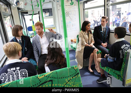 The Duke and Duchess of Sussex talks to students from Albert Park Primary School, Port Melbourne Primary School and Elwood Secondary College while riding on a tram in Melbourne, on the third day of the royal couple's visit to Australia. Stock Photo