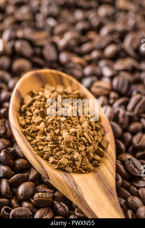 The instant coffee and coffee beans in wooden spoon. Stock Photo