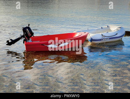 Finikas Bay: October,10th 2018. Two small dinghy moored by the shoreline of Finikas Bay October 10th ,2018, Syros, Greece. Editorial Image. Stock Photo