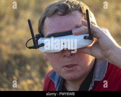 Kiev, Ukraine. 18th Oct, 2018. Drone pilot seen wearing a first-person view headset. Young man driving a quad-copter using video-goggles. Credit: Igor Golovniov/SOPA Images/ZUMA Wire/Ģ����ý Live News Stock Photo