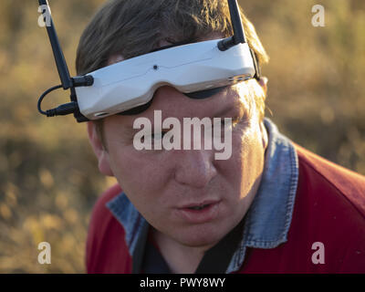 Kiev, Ukraine. 18th Oct, 2018. Drone pilot seen wearing a first-person view headset. Young man driving a quad-copter using video-goggles. Credit: Igor Golovniov/SOPA Images/ZUMA Wire/Ģ����ý Live News Stock Photo